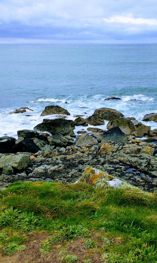Sea and rocks in Cornwall. Public speaking coaching for non-natiive professionals.